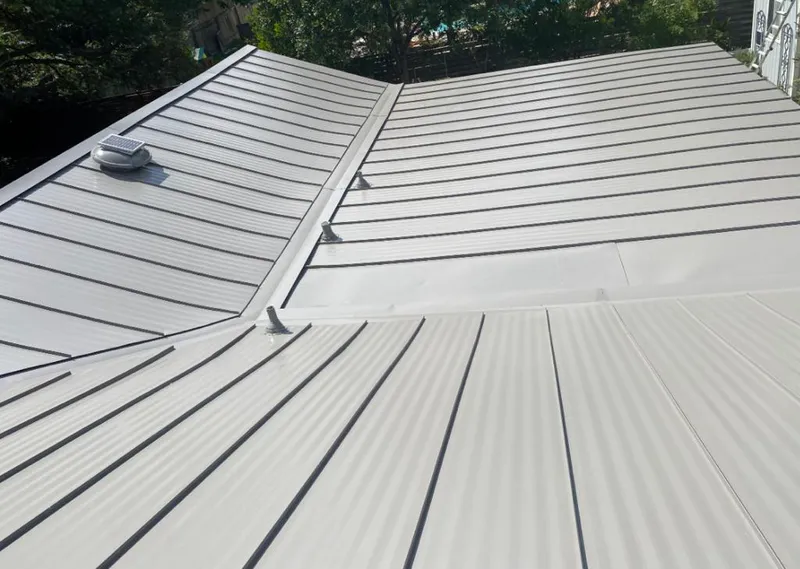 Solar attic fan installed on a metal roof for Roof Ventilation in Vashon
